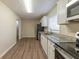 Well-appointed kitchen featuring stainless steel appliances, white cabinets, and granite countertops at 1852 Shamrock Dr, Decatur, GA 30032