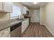 Updated kitchen boasts granite counters, stainless steel appliances, and white cabinetry at 1852 Shamrock Dr, Decatur, GA 30032