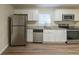 Modern kitchen with stainless steel appliances, white cabinets, and granite countertops at 1852 Shamrock Dr, Decatur, GA 30032