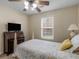 Bedroom with a bed, a small desk, a window, and wood-look floors at 221 Prominent Loop, Mcdonough, GA 30253