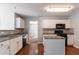 Kitchen with white cabinets, granite counters, and black appliances at 3867 Oakman Pl, Fairburn, GA 30213