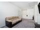 Bonus room with couch and access to other rooms at 9004 Jim Purcell Dr, Covington, GA 30014