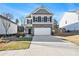 Two-story house with gray siding, brick accents, and a two-car garage at 9004 Jim Purcell Dr, Covington, GA 30014