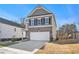 Two-story house with gray siding, brick accents, and a two-car garage at 9004 Jim Purcell Dr, Covington, GA 30014