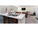 Kitchen island with double sink overlooking living room at 9004 Jim Purcell Dr, Covington, GA 30014