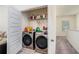 Laundry room with washer, dryer, and shelving at 9004 Jim Purcell Dr, Covington, GA 30014