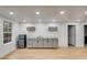 Basement kitchenette with gray cabinets, marble countertops, and refrigerator at 1409 Northgate Dr, Villa Rica, GA 30180