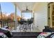 Charming covered porch with swing, bar seating, and wooded views at 2111 Cooper Lake Se Rd, Smyrna, GA 30080