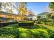 Spacious backyard with lush landscaping, fountain, and charming white house at 2111 Cooper Lake Se Rd, Smyrna, GA 30080