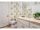 Bright bathroom with floral wallpaper, white cabinetry, and a tiled floor at 2111 Cooper Lake Se Rd, Smyrna, GA 30080