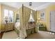 Charming bedroom with a four-poster bed, soft green and yellow decor, and ample natural light at 2111 Cooper Lake Se Rd, Smyrna, GA 30080