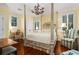 Lovely bedroom with four-poster bed, chandelier, and comfortable seating at 2111 Cooper Lake Se Rd, Smyrna, GA 30080