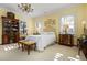 Large bedroom with elegant chandelier, antique furniture and carpet flooring at 2111 Cooper Lake Se Rd, Smyrna, GA 30080