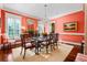 Dining room with glass-top table, wood chairs with striped cushions, and chandelier at 2111 Cooper Lake Se Rd, Smyrna, GA 30080