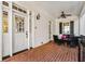 Covered front porch with brick flooring, white siding, and black shutters at 2111 Cooper Lake Se Rd, Smyrna, GA 30080