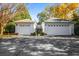 Two-car garage with white doors, concrete driveway, and glimpse of the home's entrance at 2111 Cooper Lake Se Rd, Smyrna, GA 30080
