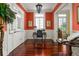 Bright home office with coral walls, white trim, and built-in desk at 2111 Cooper Lake Se Rd, Smyrna, GA 30080