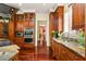 Modern kitchen with double ovens, wine fridge, granite counters, and rich wood cabinets at 2111 Cooper Lake Se Rd, Smyrna, GA 30080