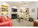 Cozy living room with fireplace, patterned rug, floral sofa, and red couch at 2111 Cooper Lake Se Rd, Smyrna, GA 30080