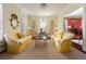 Elegant living room with yellow tufted sofas, decorative rug, and natural light at 2111 Cooper Lake Se Rd, Smyrna, GA 30080