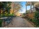 Brick patio with wrought iron furniture next to a house with a porch at 2111 Cooper Lake Se Rd, Smyrna, GA 30080