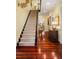 Carpeted staircase with black railing, hardwood floors, and hallway view at 2111 Cooper Lake Se Rd, Smyrna, GA 30080