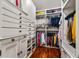Spacious walk-in closet with built-in shelving, drawers, and ample hanging space at 2111 Cooper Lake Se Rd, Smyrna, GA 30080