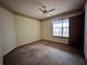 Spacious bedroom with wall-to-wall carpeting, a ceiling fan, and door to a deck at 7074 Babbling Brook Dr, Jonesboro, GA 30236