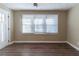 Bright living room with large windows and wood-look flooring at 1807 Oakmont Nw Dr, Atlanta, GA 30314