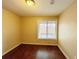 Simple bedroom with window and wood floors at 1153 Village Main St, Stone Mountain, GA 30088