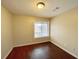 Simple bedroom with window and wood floors at 1153 Village Main St, Stone Mountain, GA 30088