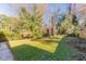 Large backyard with grassy area and trees at 3457 Springlake Dr, Decatur, GA 30032