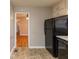 Kitchen with black appliances and view into living room at 3457 Springlake Dr, Decatur, GA 30032
