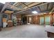 Large, unfinished basement space with exposed framing, concrete floors, and storage items at 4378 Ridge Ct, Loganville, GA 30052