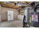 Basement laundry room includes washer, dryer, refrigerator, and water heater at 4378 Ridge Ct, Loganville, GA 30052