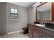 Modern bathroom boasts dark granite countertop, updated fixtures, and tiled shower at 4378 Ridge Ct, Loganville, GA 30052