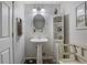 Basement bathroom with pedestal sink, decorative shelving, and small bench at 4378 Ridge Ct, Loganville, GA 30052