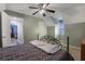 Bedroom featuring a metal bed frame, ceiling fan, and carpeted floors at 4378 Ridge Ct, Loganville, GA 30052