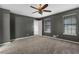 Spacious bedroom with gray walls, ceiling fan, carpet, and large windows at 4378 Ridge Ct, Loganville, GA 30052