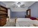 Cozy bedroom with wooden furniture and soft carpet under a ceiling fan at 4378 Ridge Ct, Loganville, GA 30052
