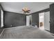 Spacious bedroom with gray walls, carpet, ceiling fan, and ensuite bathroom access at 4378 Ridge Ct, Loganville, GA 30052