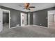 Large bedroom with gray walls, carpeted floors, and a ceiling fan at 4378 Ridge Ct, Loganville, GA 30052