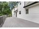 Large gray deck with railing and a few pieces of furniture, along the back of the house at 4378 Ridge Ct, Loganville, GA 30052