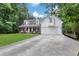 Charming two-story home with a front porch, lush lawn, and attached garage at 4378 Ridge Ct, Loganville, GA 30052