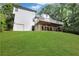 View of the back of the house with a deck and a sloped backyard at 4378 Ridge Ct, Loganville, GA 30052