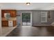 Open-concept living and dining area with wood floors, sliding glass door, and view of the kitchen at 4378 Ridge Ct, Loganville, GA 30052