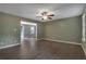 Spacious living room with hardwood floors, ceiling fan, and doorway leading to another living area at 4378 Ridge Ct, Loganville, GA 30052