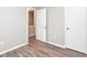Empty bedroom featuring wood-look floors, white doors, and light gray walls at 1344 Mill Lake Cir, Stone Mountain, GA 30088