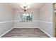 Dining room with wood-look floors, chandelier, and large window with natural light at 1344 Mill Lake Cir, Stone Mountain, GA 30088