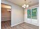 Dining area with sliding glass doors, wood-look flooring, and a view of the backyard at 1344 Mill Lake Cir, Stone Mountain, GA 30088